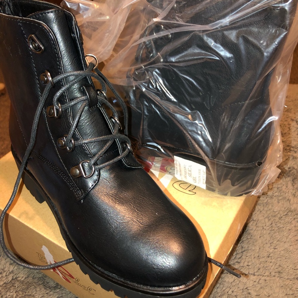 Black combat boots with little heel .